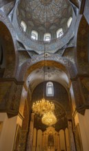 Elaborately decorated church dome with a large chandelier and artistic details, Inside the