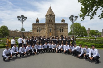 A large group of graduates poses in front of a church, historic, most important Armenian Orthodox