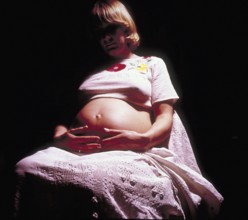 Pregnant woman with her hands on her stomach, Bavaria, Germany
