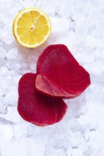 Fresh tuna and lemon, on ice ready, for preparation, at a seafood market