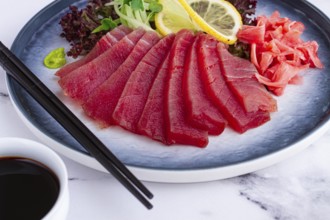 Tuna sashimi, with side dish, on a marble table, homemade, no people