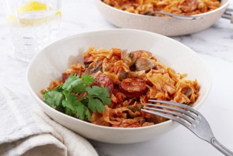 Bigos, Polish dish bigos, on the table, pan with stewed meat, with cabbage, chorizo sausages,