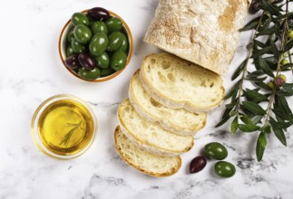 Appetizer, sliced ciabatta bread, with olive oil, green olives, Chalkidiki olives, classic Green