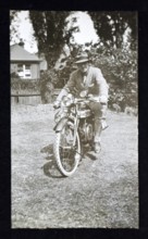 Man sitting on riding motorcycle, England, UK 1920s 1930s