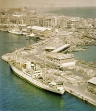 View from cable car of cargo ship 'Fylgia' in port, view to Barceloneta area, city of Barcelona,