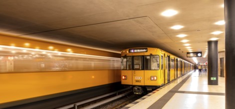 Dynamic scene of a Berlin underground in typical yellow colour, long exposure with blur effect,