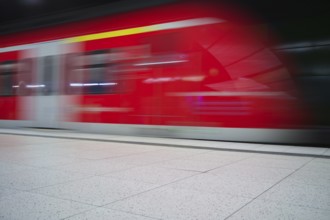Underground arriving S-Bahn, train, class 420 in traffic red, platform, stop, station city centre,