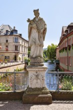 Ettlingen, Germany - August 13th 2025: Statue of Saint John of Nepomuk on Rathausbrücke bridge over