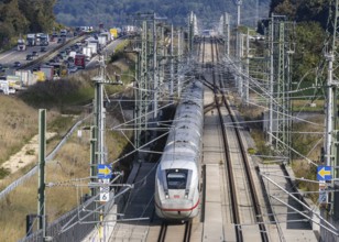 A8 motorway with traffic jam. The new high-speed railway line of Deutsche Bahn AG runs parallel