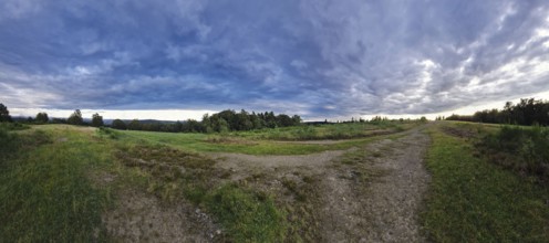 Vast landscape with dramatic clouds and a meandering path. Heaths and rough grassland nature