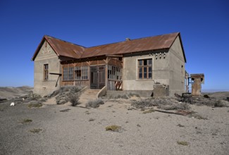 Dilapidated building in the desert sand, Pomona, restricted diamond area, near Lüderitz, Karas