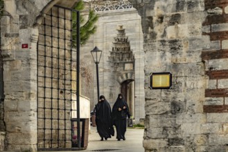 Women veiled in black with niqab at the Fatih Mosque in Fatih, Istanbul, Turkey