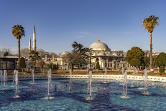 Fountain in Sultan Ahmet Park and the Sultanahmet Madrasa in Istanbul, Turkey
