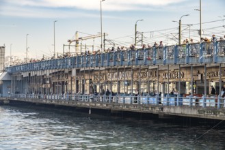 Anglers and restaurants on the Galata Bridge in Istanbul, Turkey