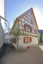 Half-timbered house with red shutters, Höllgasse, Wiesloch, Baden-Württemberg, Germany
