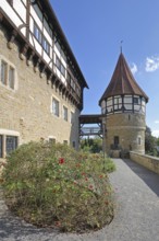 Water tower of the medieval Zollern castle built around 1255, half-timbered house, flags, stone