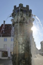 Town hall fountain with reliefs and figures by Klaus Ringwald 1998 in backlight, bronze sculptures,
