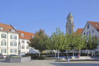 Obertorplatz with church tower of the collegiate church of St James, benches, people sitting,