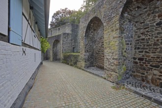 Historic town wall and half-timbered house with shutters, archways, Turmstraße, Bad Münstereifel,
