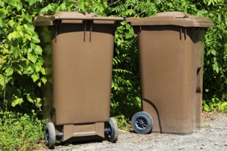 Brown plastic portable composting bins for depositing organic materials and leftover foods in,