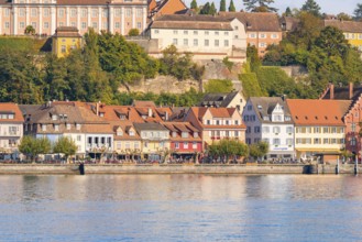 Historic row of houses on the lake with colourful architecture and autumnal trees, Meersburg, Lake