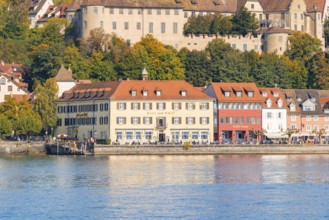 Historic buildings on the lakeshore with autumnal vegetation in the background, Meersburg, Lake