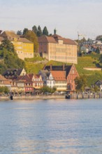 Buildings and hills on the shore of a lake, autumnal colours, Meersburg, Lake Constance, Germany