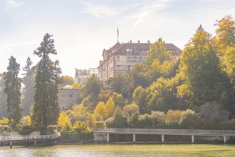 Castle on a wooded hill with autumnal trees, Mainau Island, Lake Constance, Germany