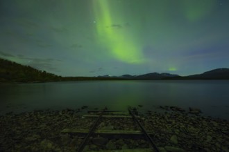 Magical northern lights over Lake Torneträsk at the boathouse
