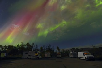 Where heaven and earth shine - campers under the dancing Northern Lights in Scandinavia