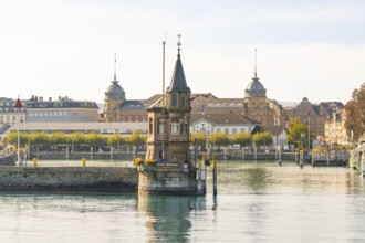 Striking tower in the water with historic buildings in the background, Constance, Lake Constance,