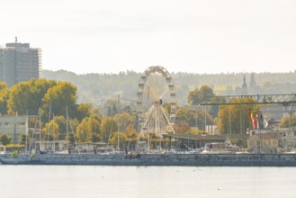 Harbour panorama with Ferris wheel and autumnal trees under a clear sky, Constance, Lake Constance,