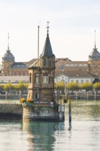 Historic tower on the water surrounded by autumnal city views, Constance, Lake Constance, Germany