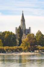 Majestic church tower surrounded by autumnal trees under a clear sky, Constance, Lake Constance,
