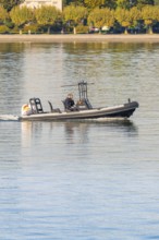 Small police motorboat on calm water with two people on board, Constance, Lake Constance, Germany
