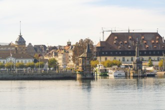 Historic harbour view with boats and buildings at calm lake and autumn atmosphere, Constance, Lake