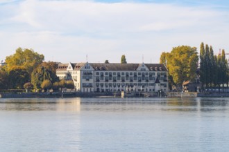 Historic architecture on the lakeshore, surrounded by autumnal trees, Constance, Lake Constance,