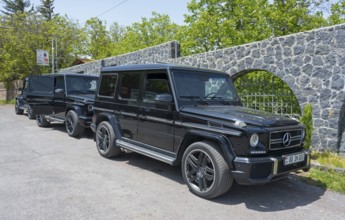 Two black Mercedes off-road vehicles parked next to each other in a car park, Mercedes-Benz