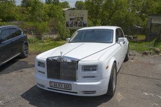 A white Rolls-Royce in a car park under trees on a sunny day, Rolls-Royce Phantom VII, Aragazotn