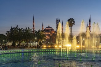 Fountain in Sultan Ahmet Park and the Blue Mosque or Sultan Ahmed Mosque at dusk, Istanbul, Turkey