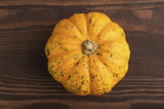 Orange Pumpkin on brown wooden background. Top view, copy space, flat lay. healthy food, vegetable,