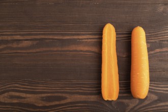 Orange Carrot on brown wooden background. Top view, copy space, flat lay. healthy food, vegetable,