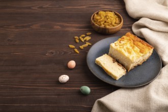 ?ottage cheese ?asserole, Curd cake, with dried apricots and raisins on brown wooden background and