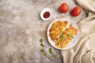 Baked chicken meat with cheese and tomatoes on brown concrete background and linen textile. top