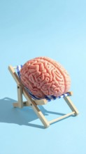 Brain relaxes on a sunbed under the summer sun, placed on a flat surface, symbol for mental health,