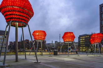 Illuminated sculptures of Dortmund roses in front of Dortmund's landmark U at dusk, Dortmund, North