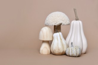 Decorative mushroom and pumpkin ornaments on brown background with copy space. Autumn seasonal