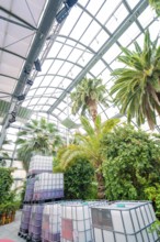 Large tanks and palm trees under a greenhouse roof with an industrial flair, Pepperoni Haus, Mainau