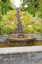 Stepped waterfall in the middle of a flowering garden with colourful plants, Mainau Island, Lake