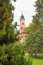 A tower with striking architecture can be seen between green trees, Mainau Island, Lake Constance,